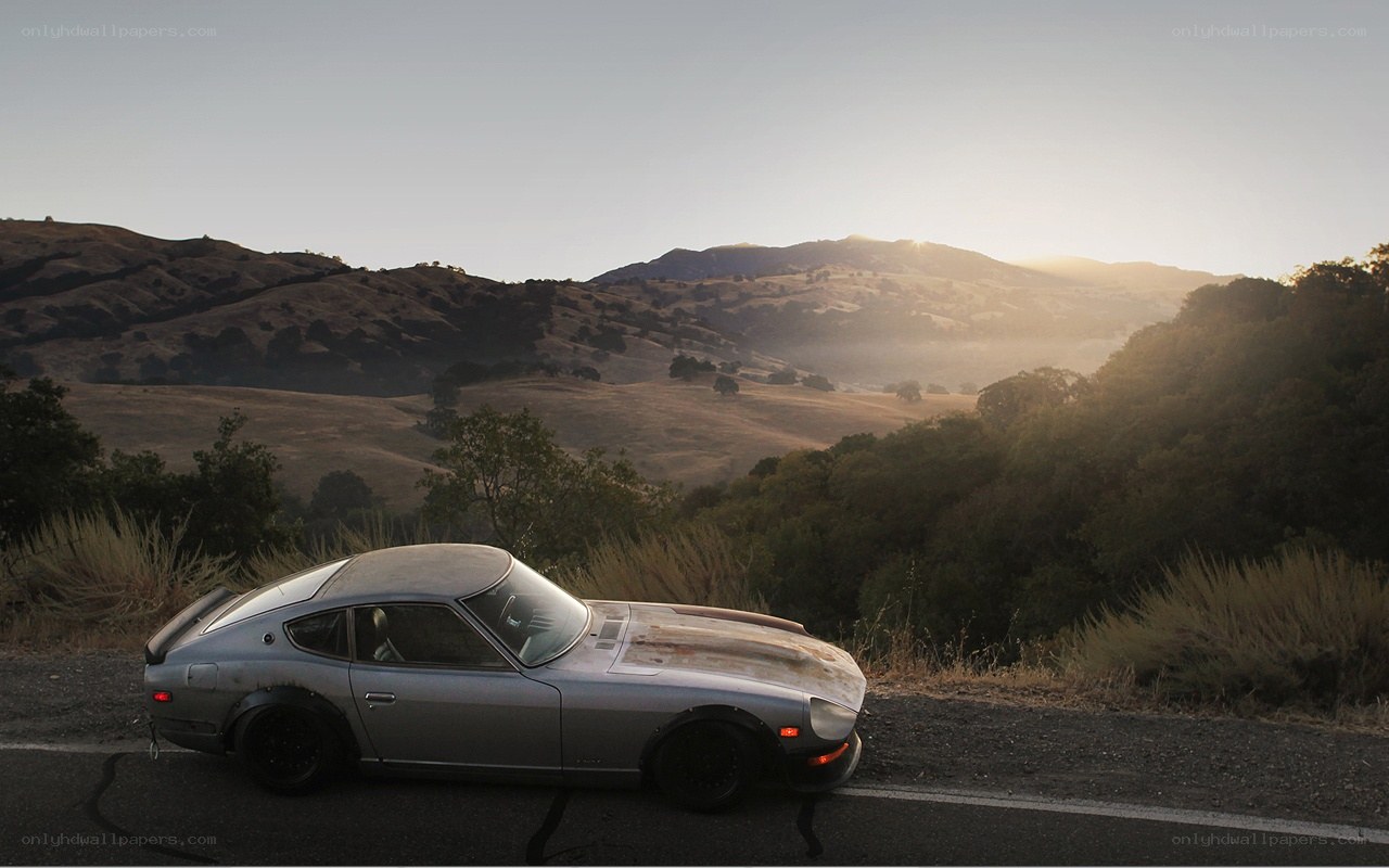 Silver car on a mountain road