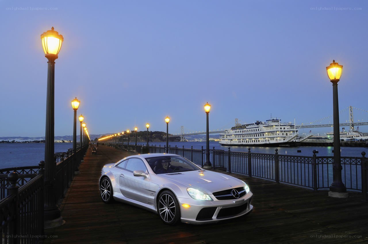 Silver car on a pier at dusk