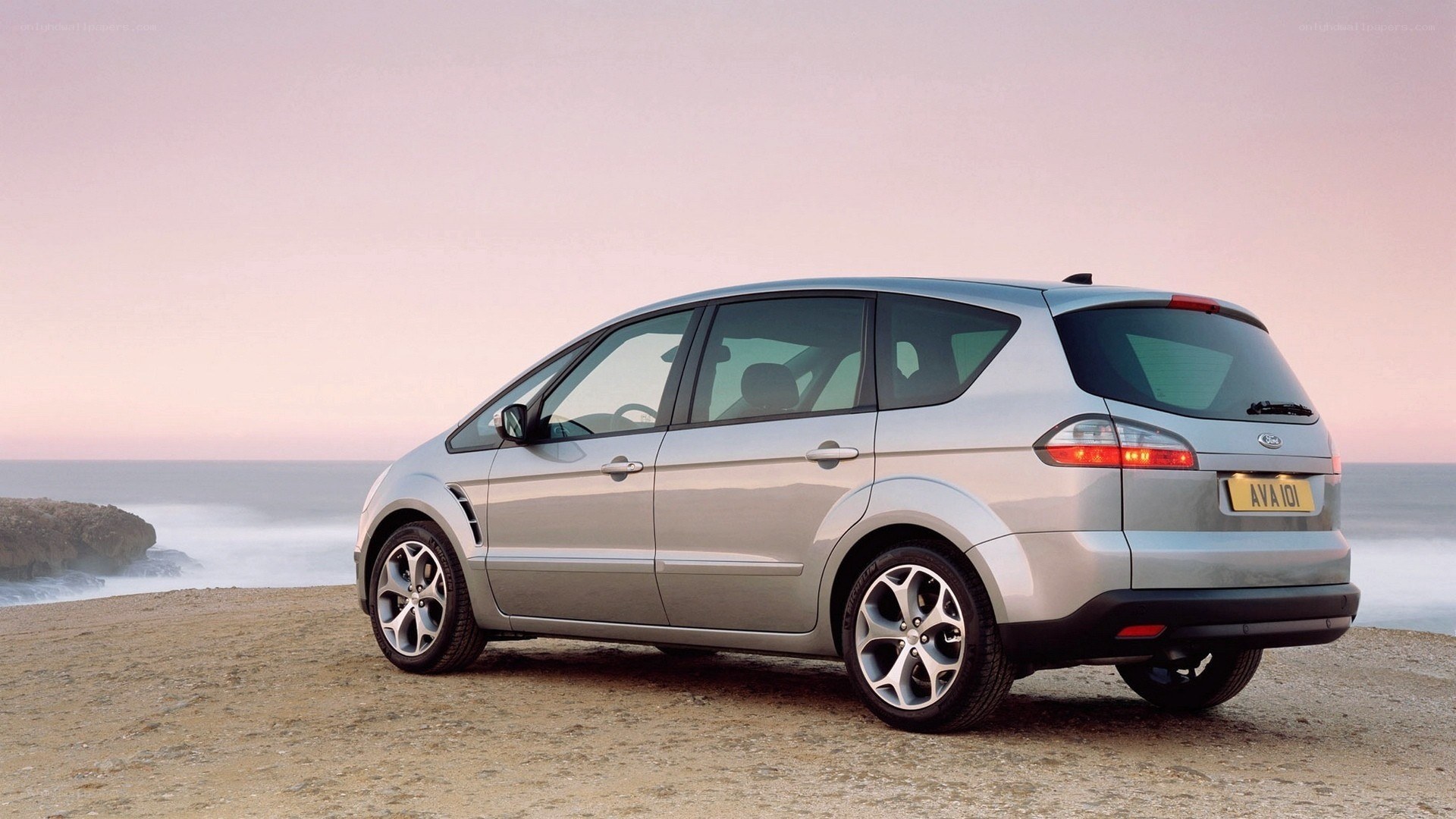 silver car on beach at sunset