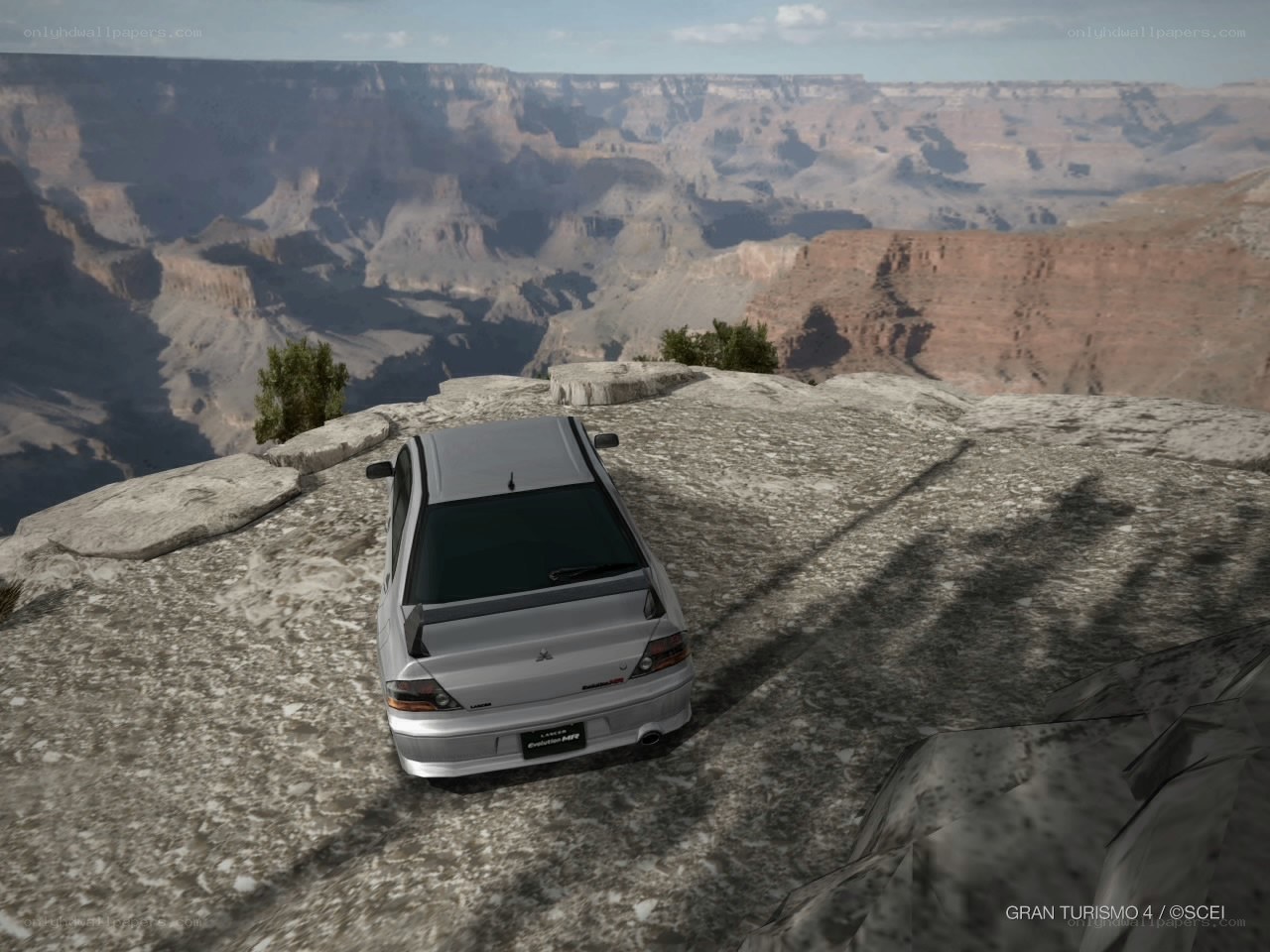 Silver car on canyon edge