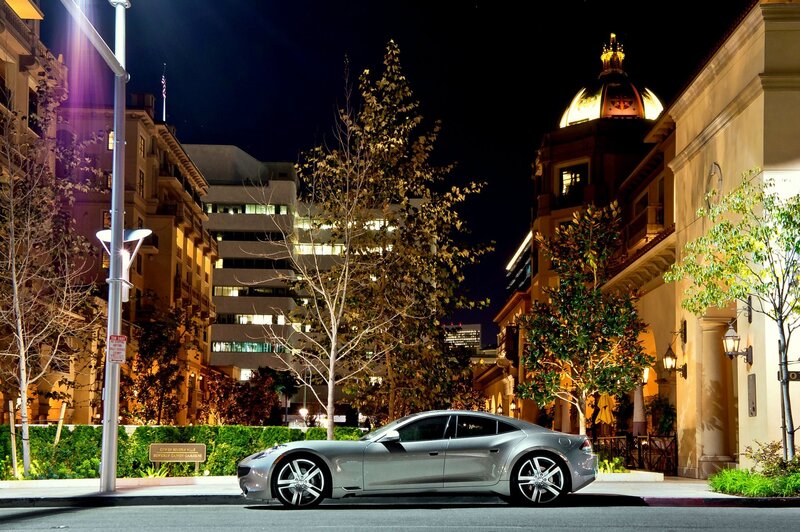 Silver car on city street at night