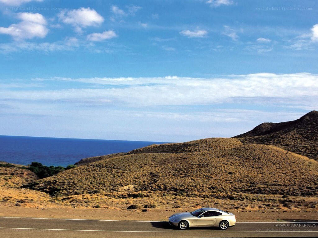 Silver car on coastal road