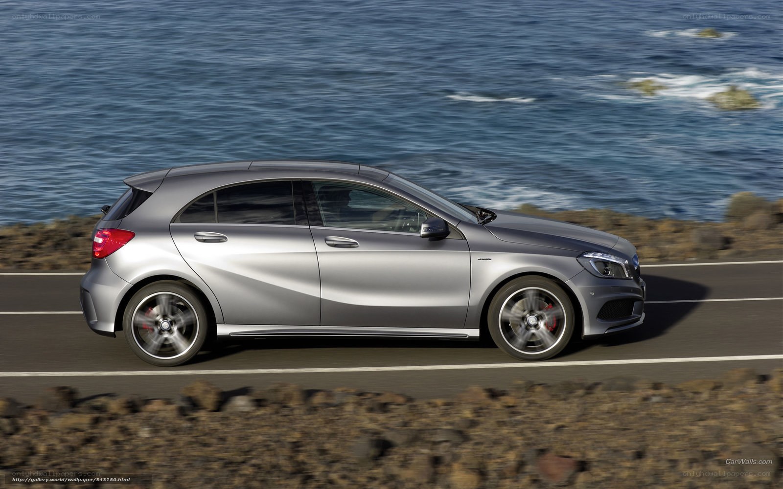 silver car on coastal road