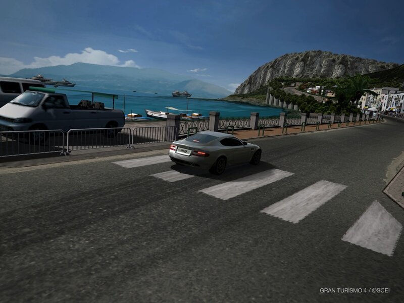 silver car on coastal road