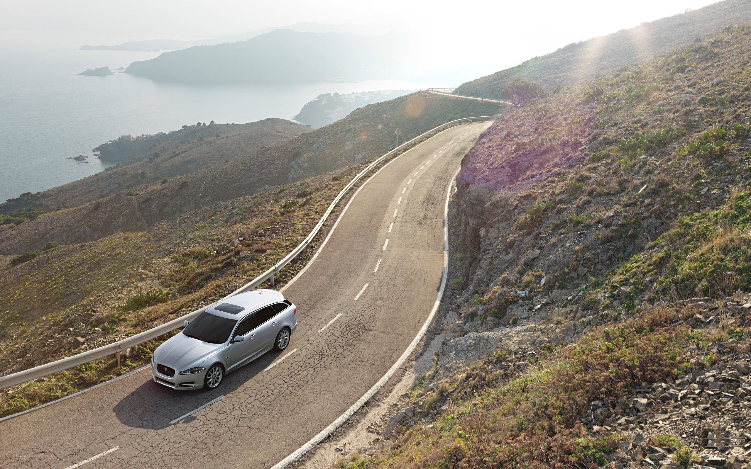Silver car on coastal road