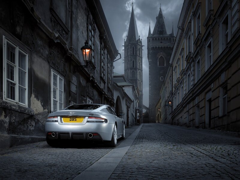 Silver car on cobblestone street