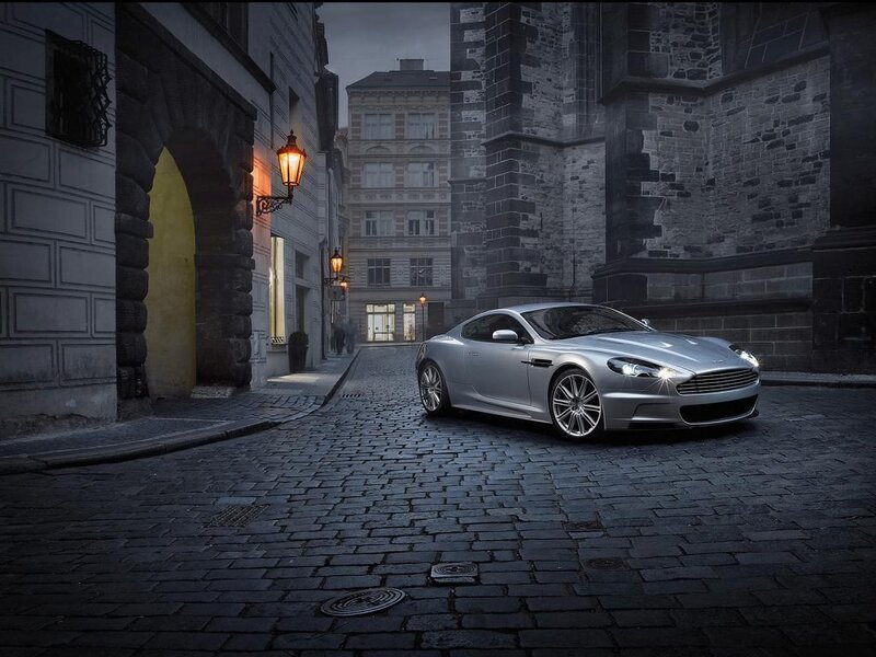 Silver car on cobblestone street