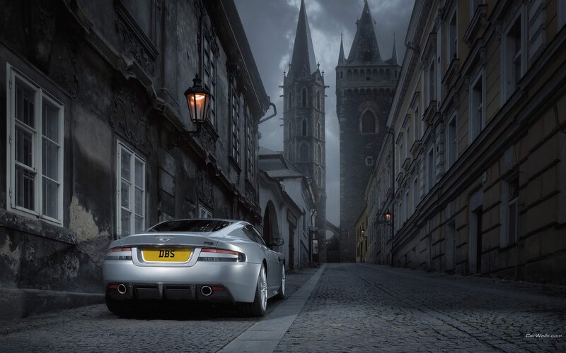 Silver car on cobblestone street