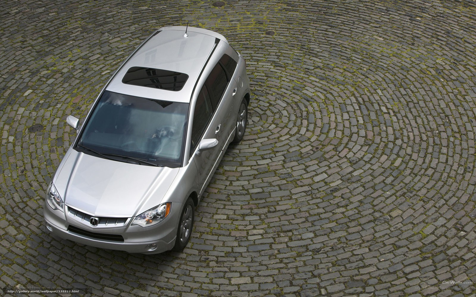 silver car on cobblestone