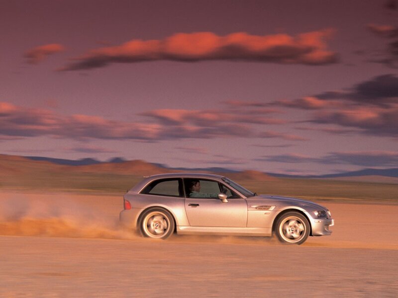 silver car on desert road