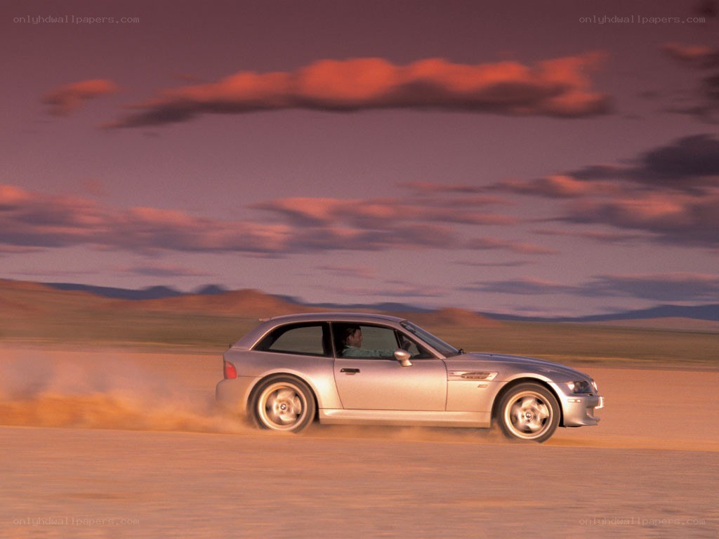 silver car on desert road