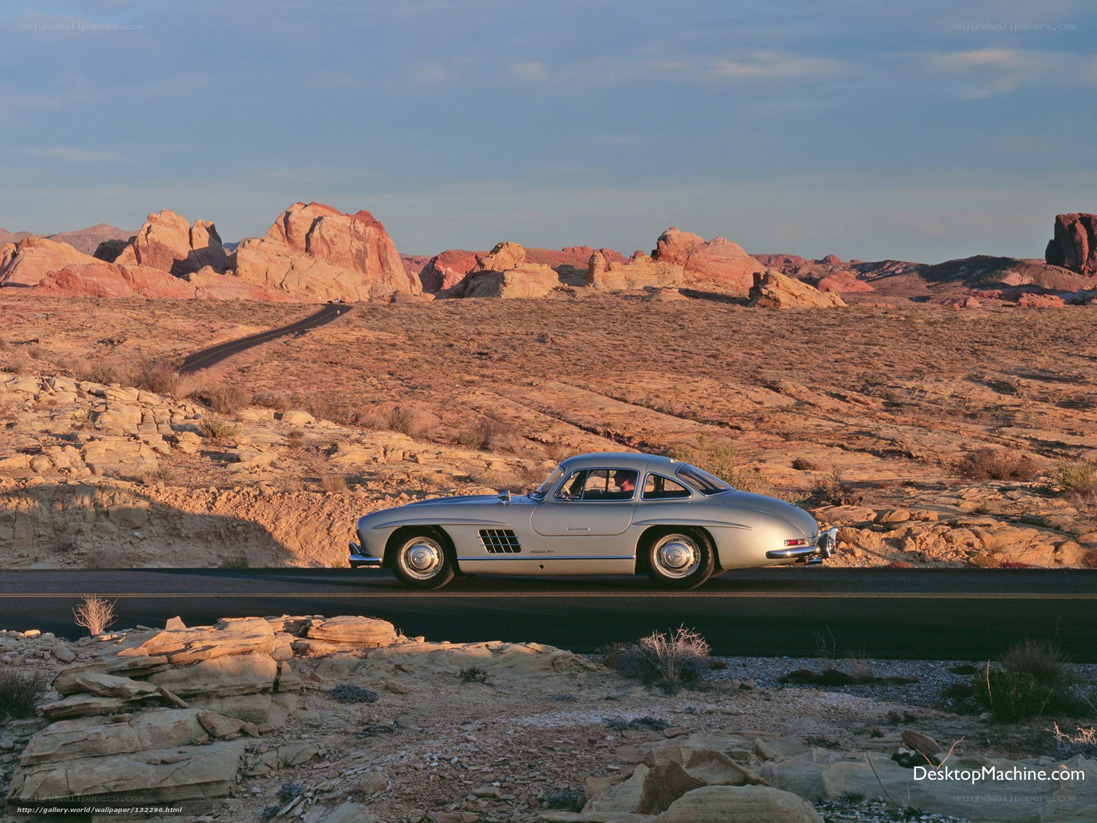 Silver car on desert road