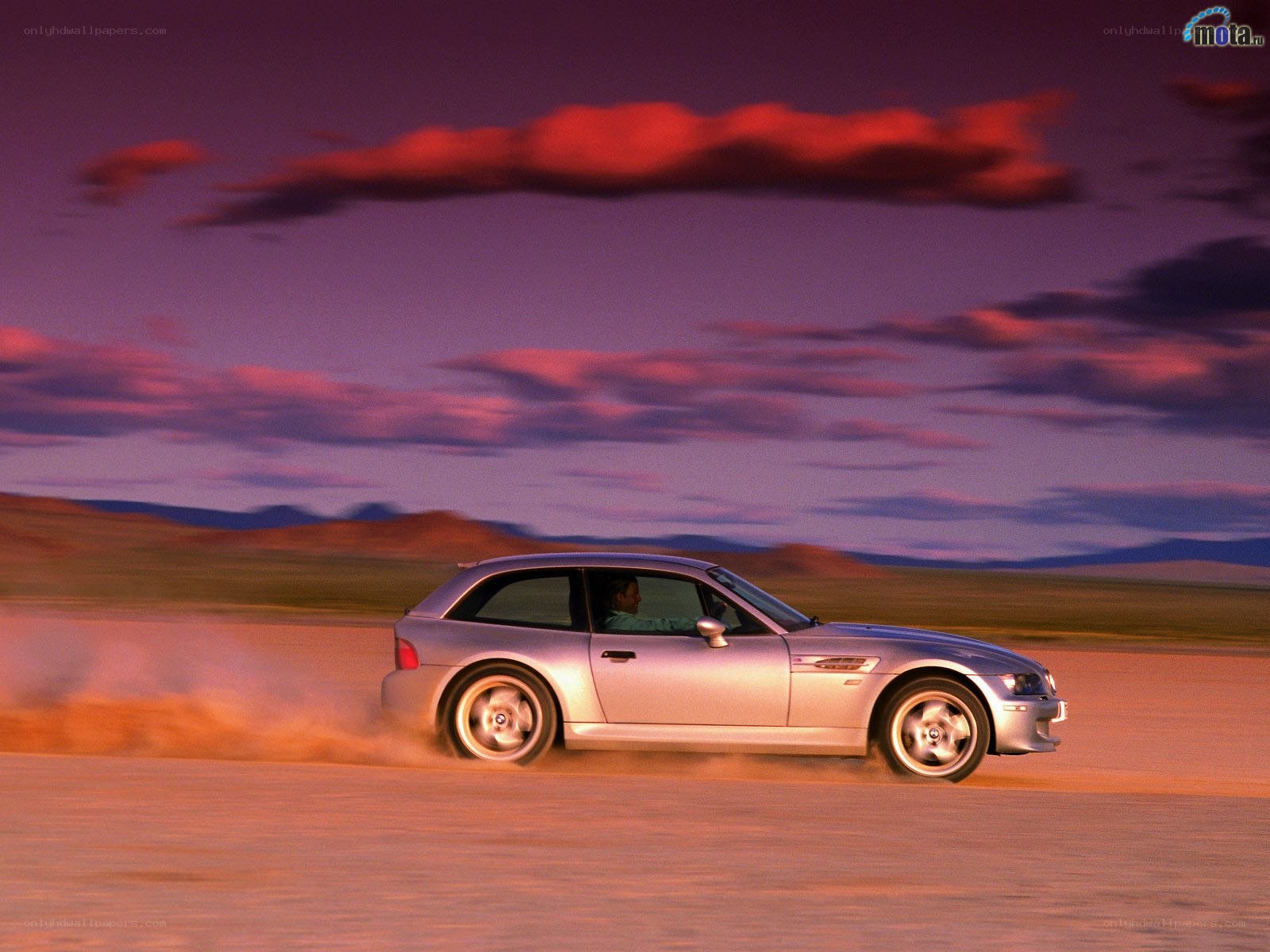 Silver car on dusty road