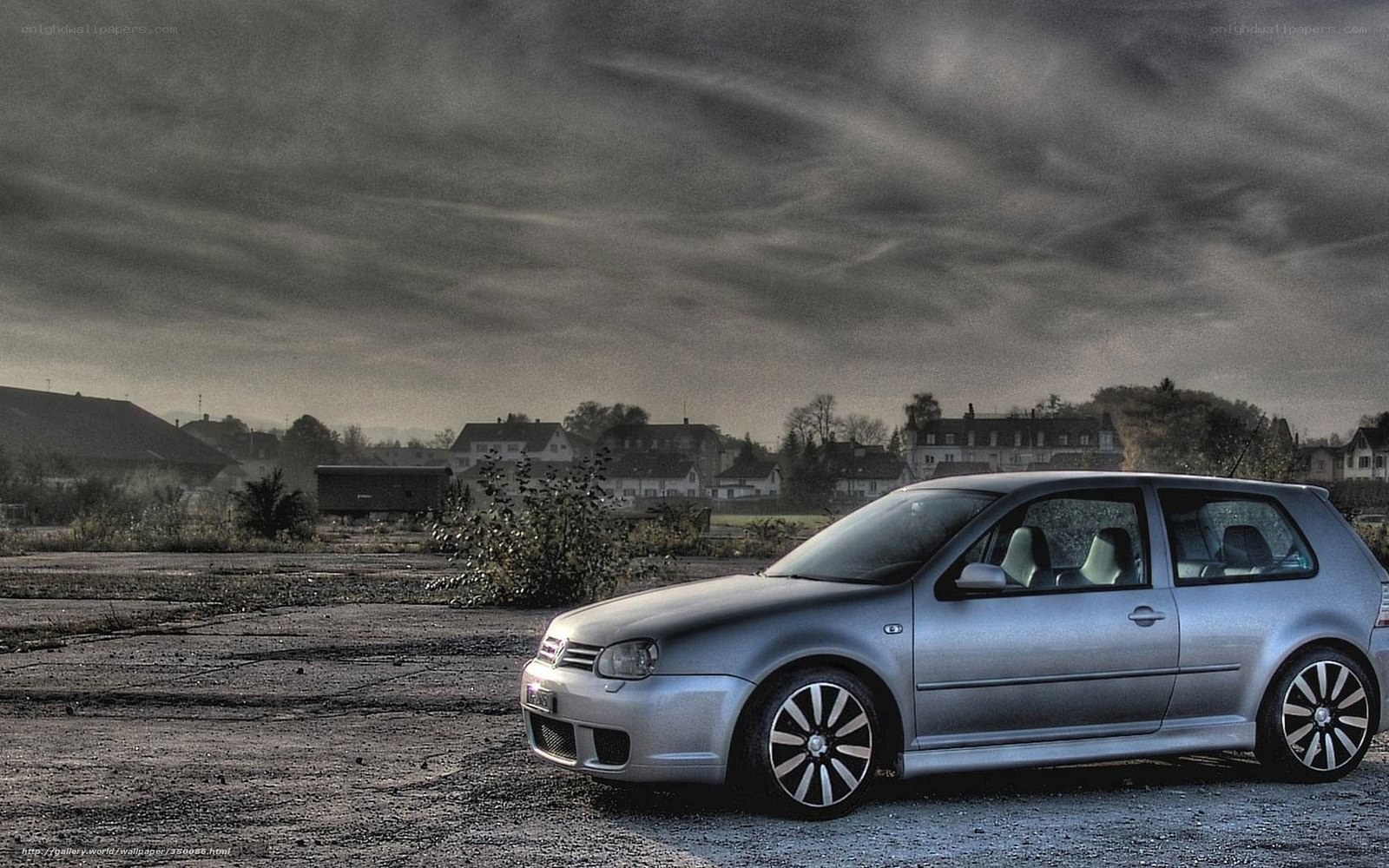 Silver car on gravel lot