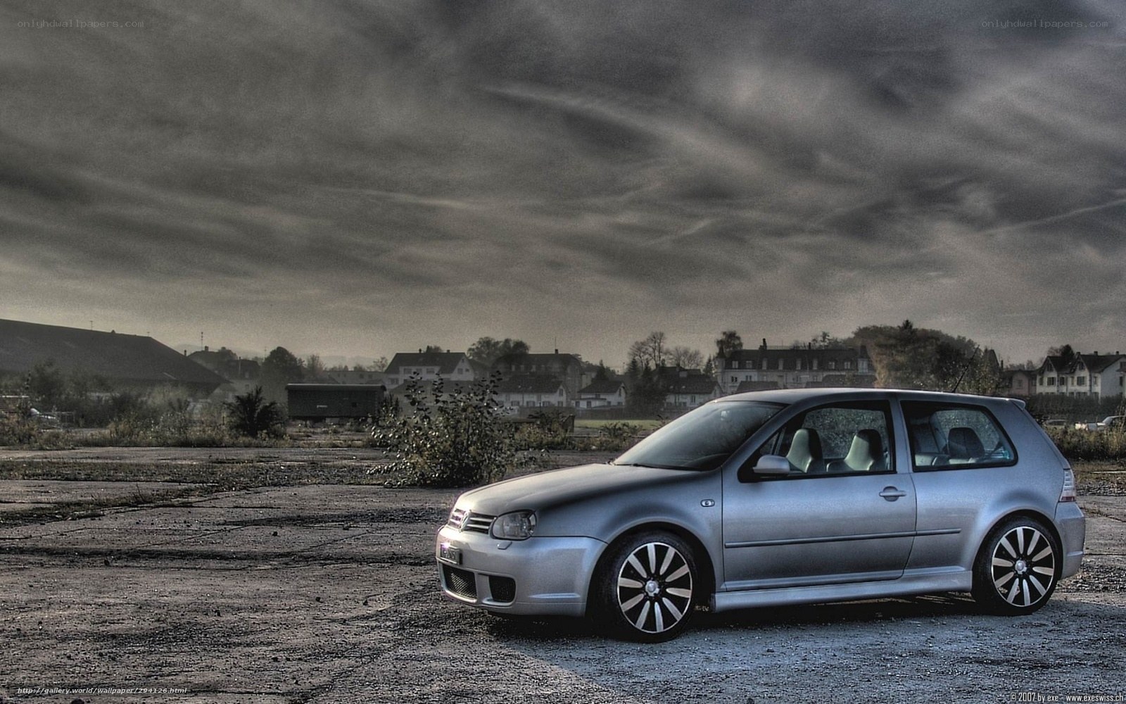 Silver car on gravel lot