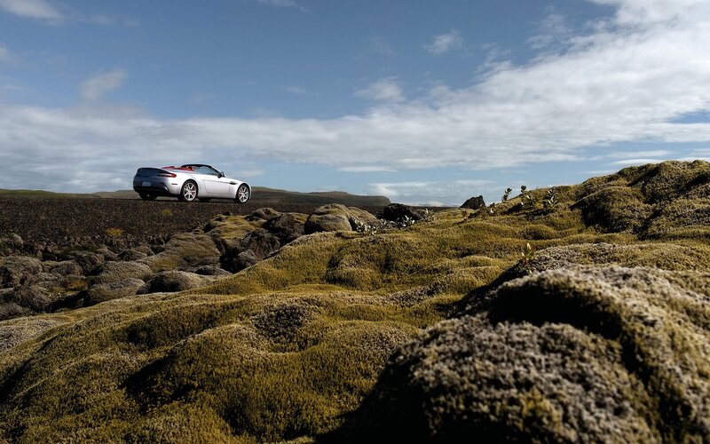 Silver car on mossy landscape