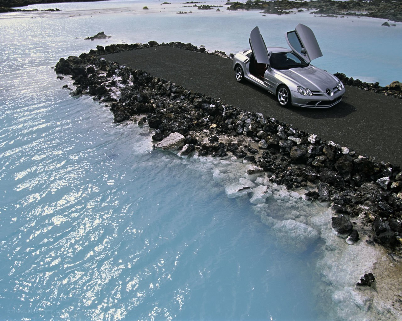 Silver car on rocky peninsula