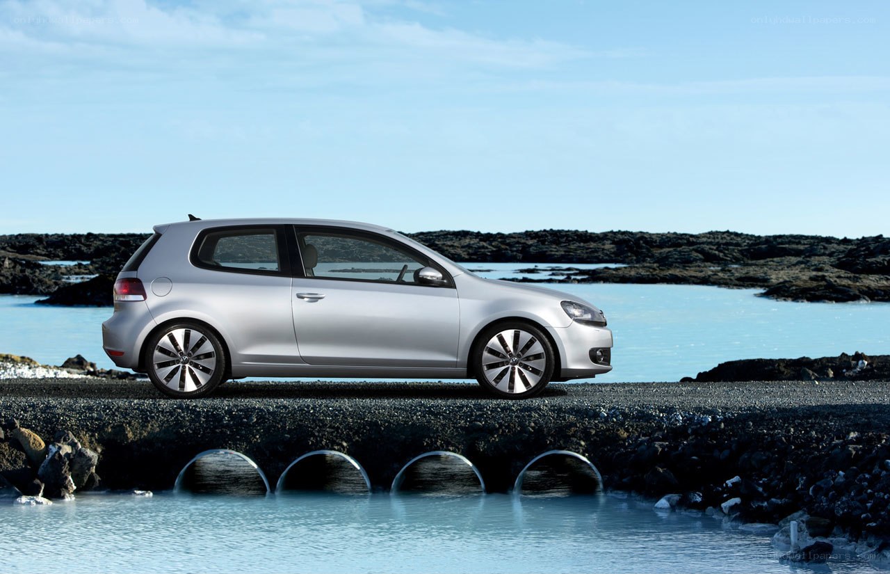 Silver car on rocky shore