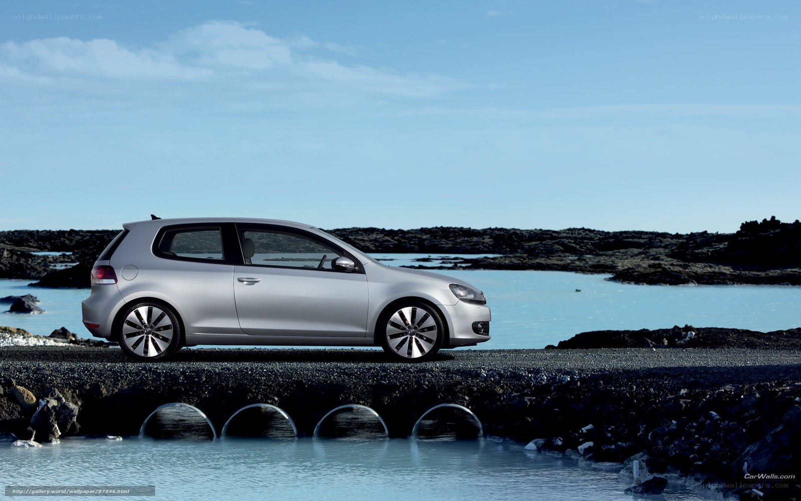 Silver car on rocky shore