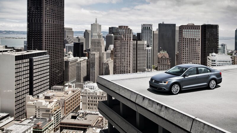 Silver car on rooftop with city view