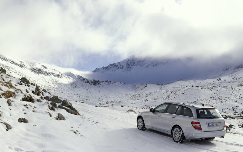 Silver car on snowy mountain road