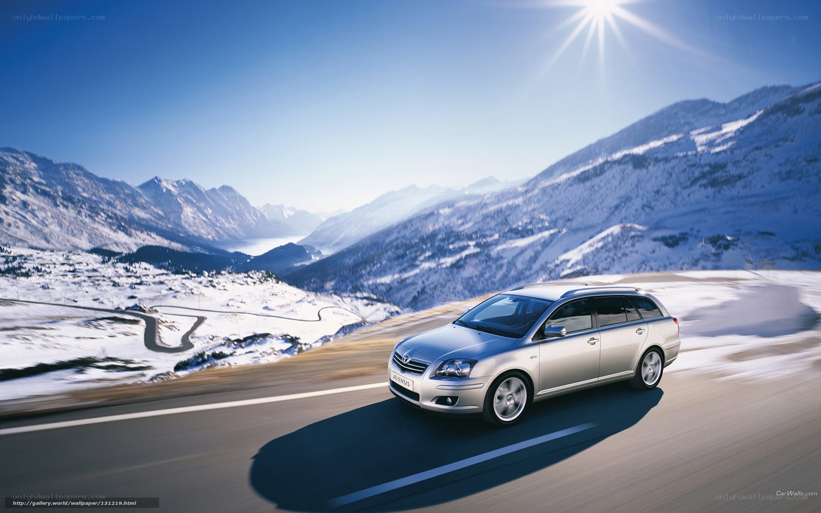 silver car on snowy mountain road