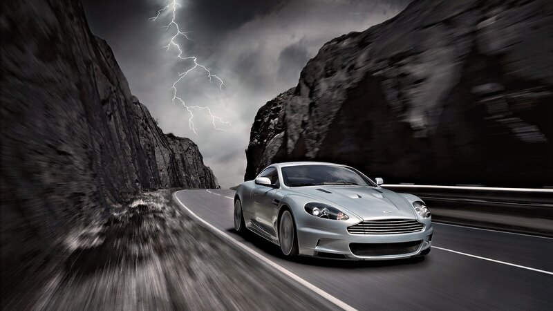 Silver car on stormy mountain road