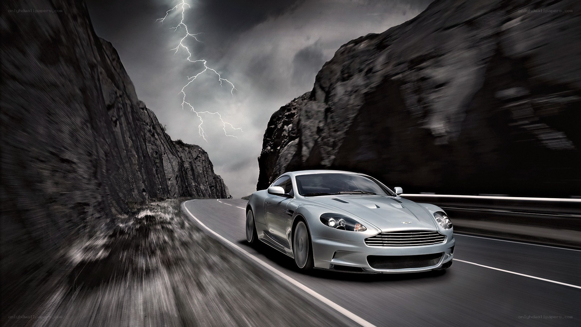 Silver car on stormy mountain road