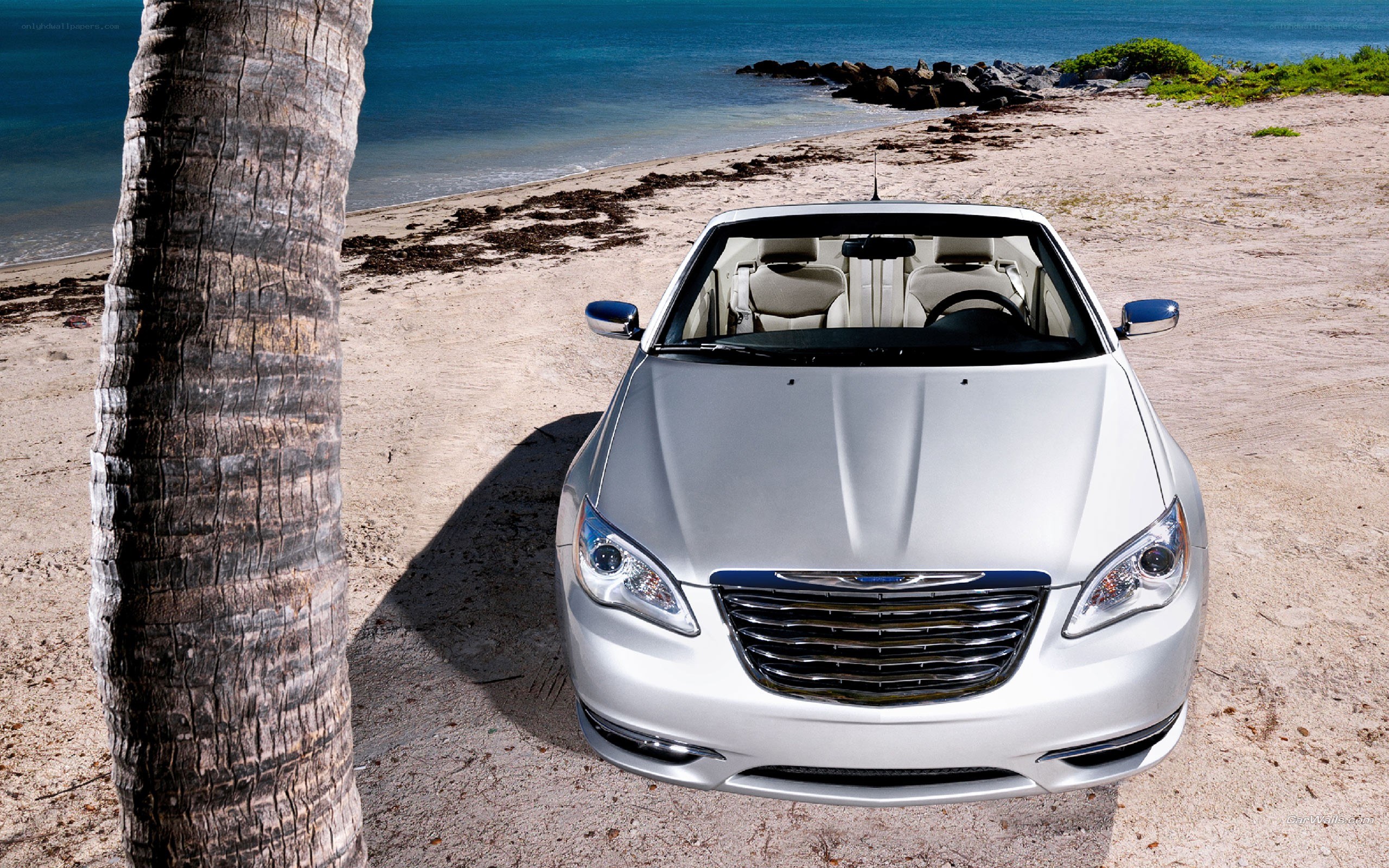Silver car on tropical beach