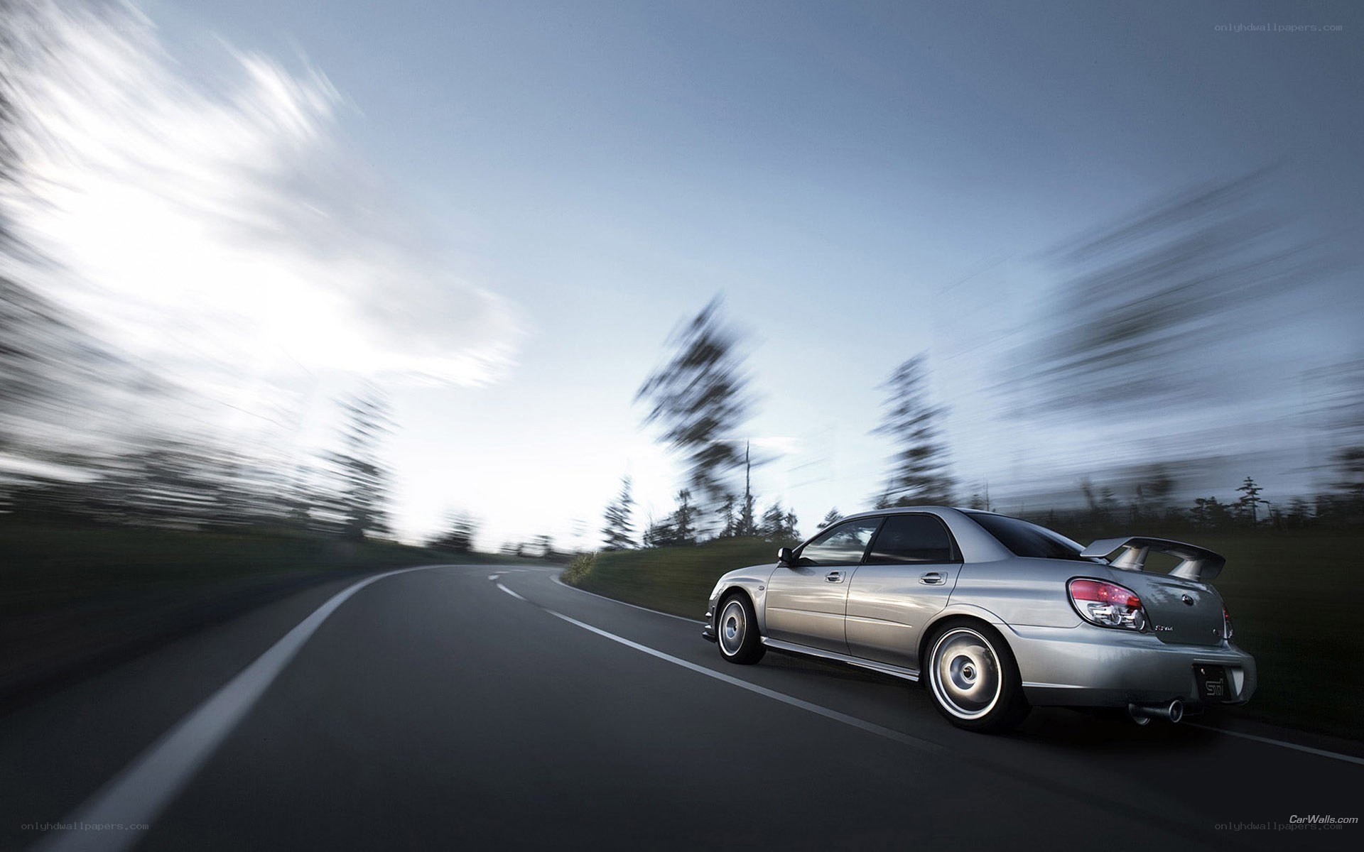silver car on winding road