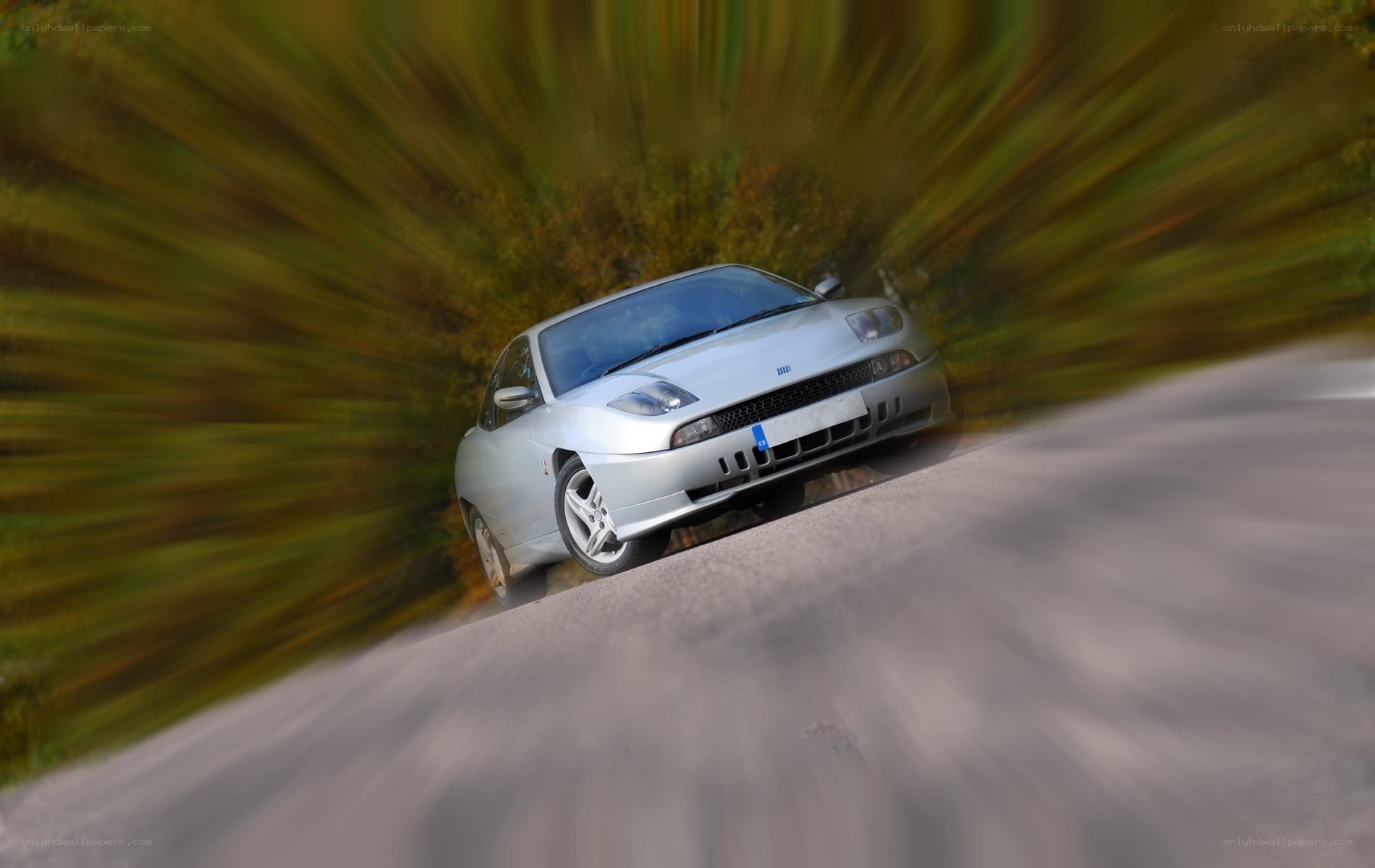 silver car on winding road
