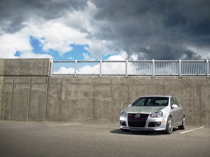 Silver car under stormy sky