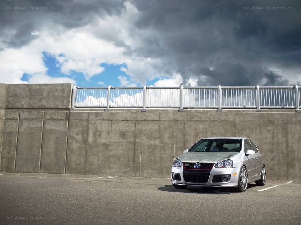 Silver car under stormy sky