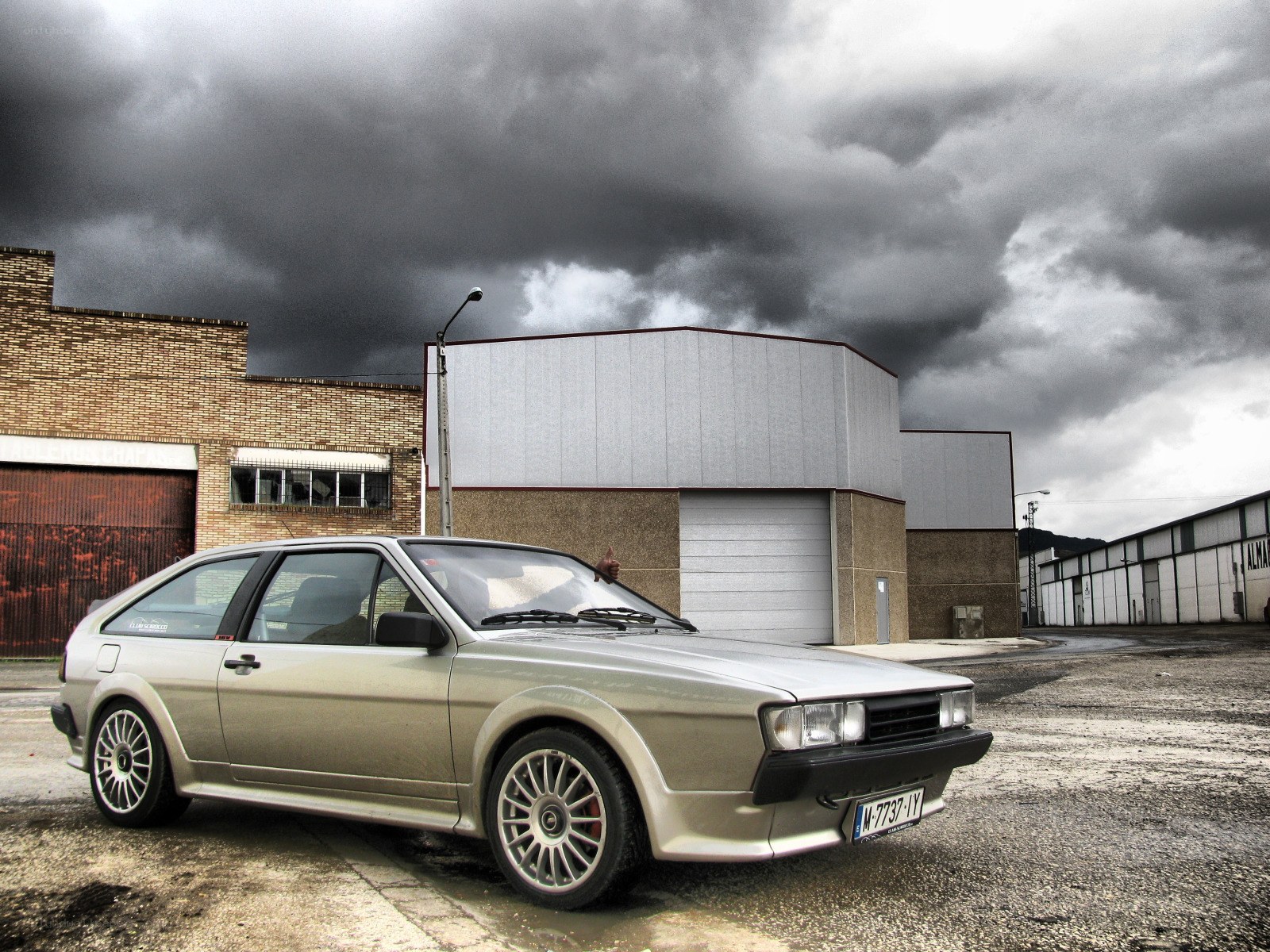 Silver car under stormy sky
