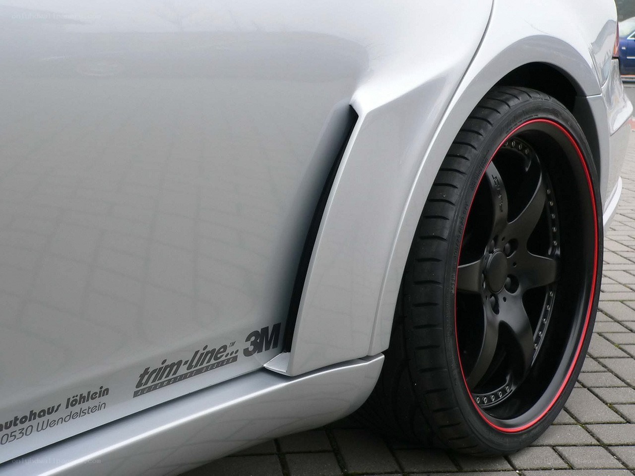 silver car with black wheels