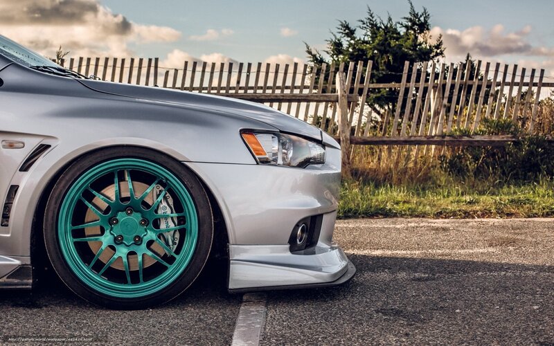 silver car with teal wheels