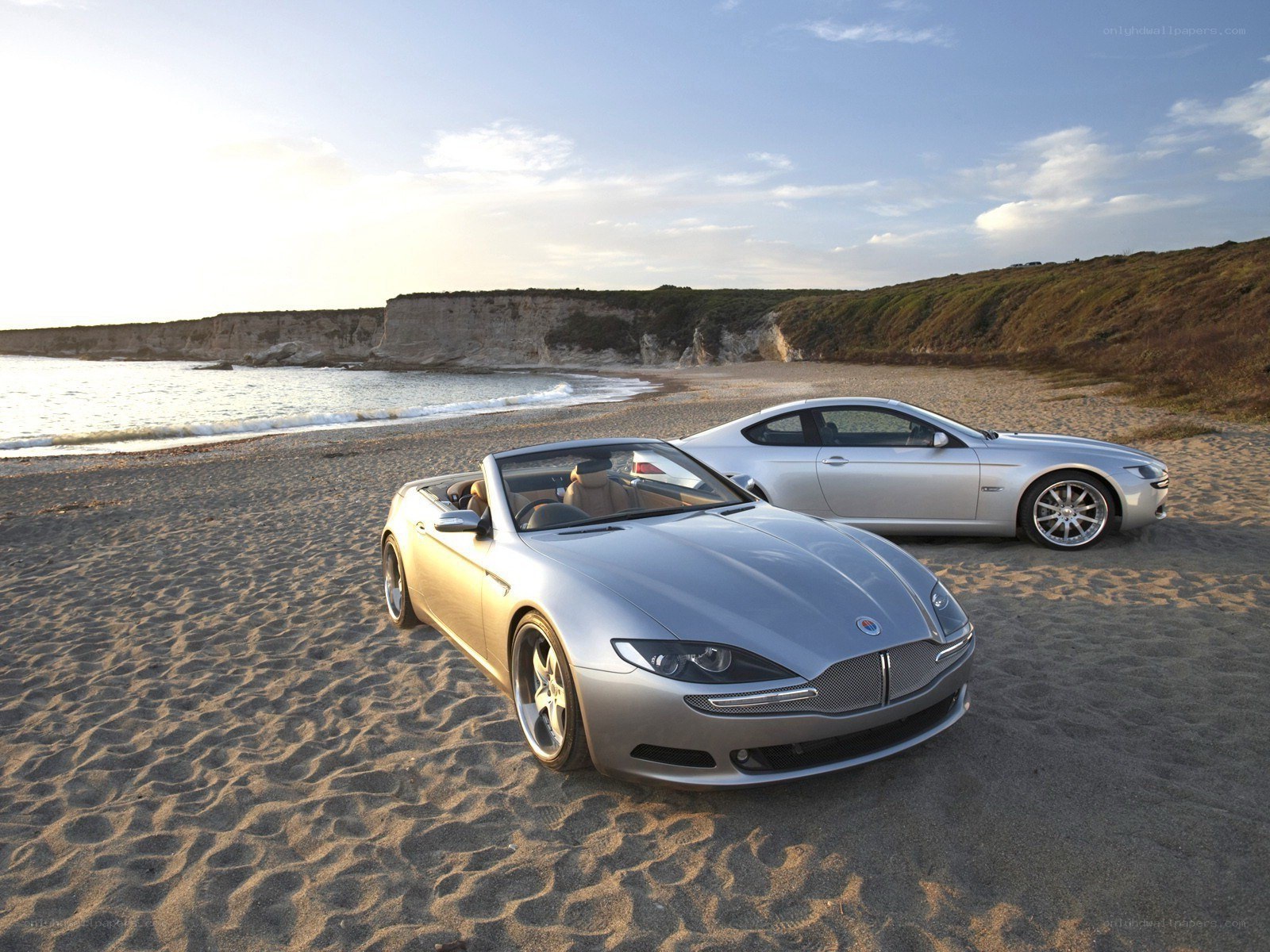 Silver cars on a beach