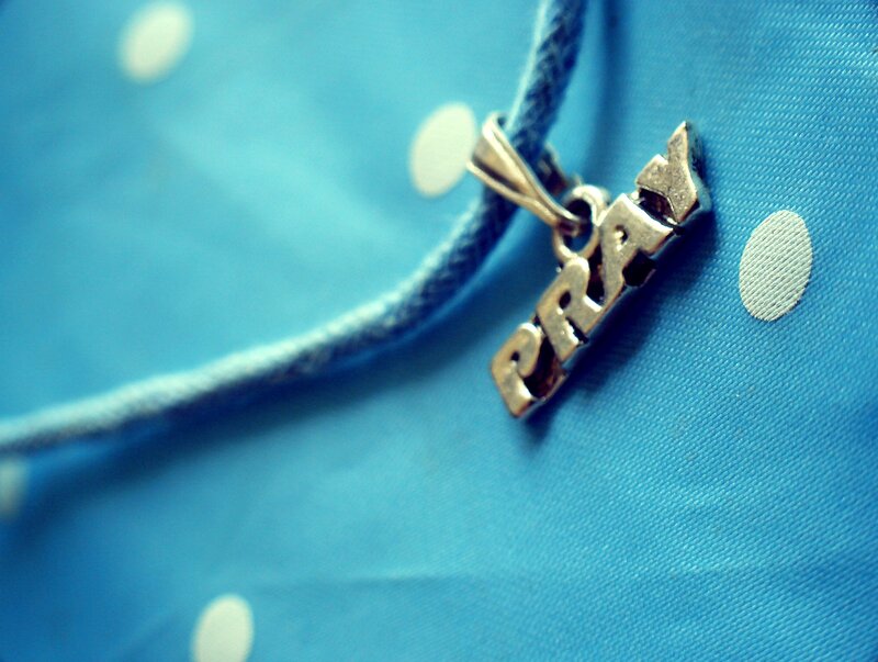Silver Charm on Blue Fabric