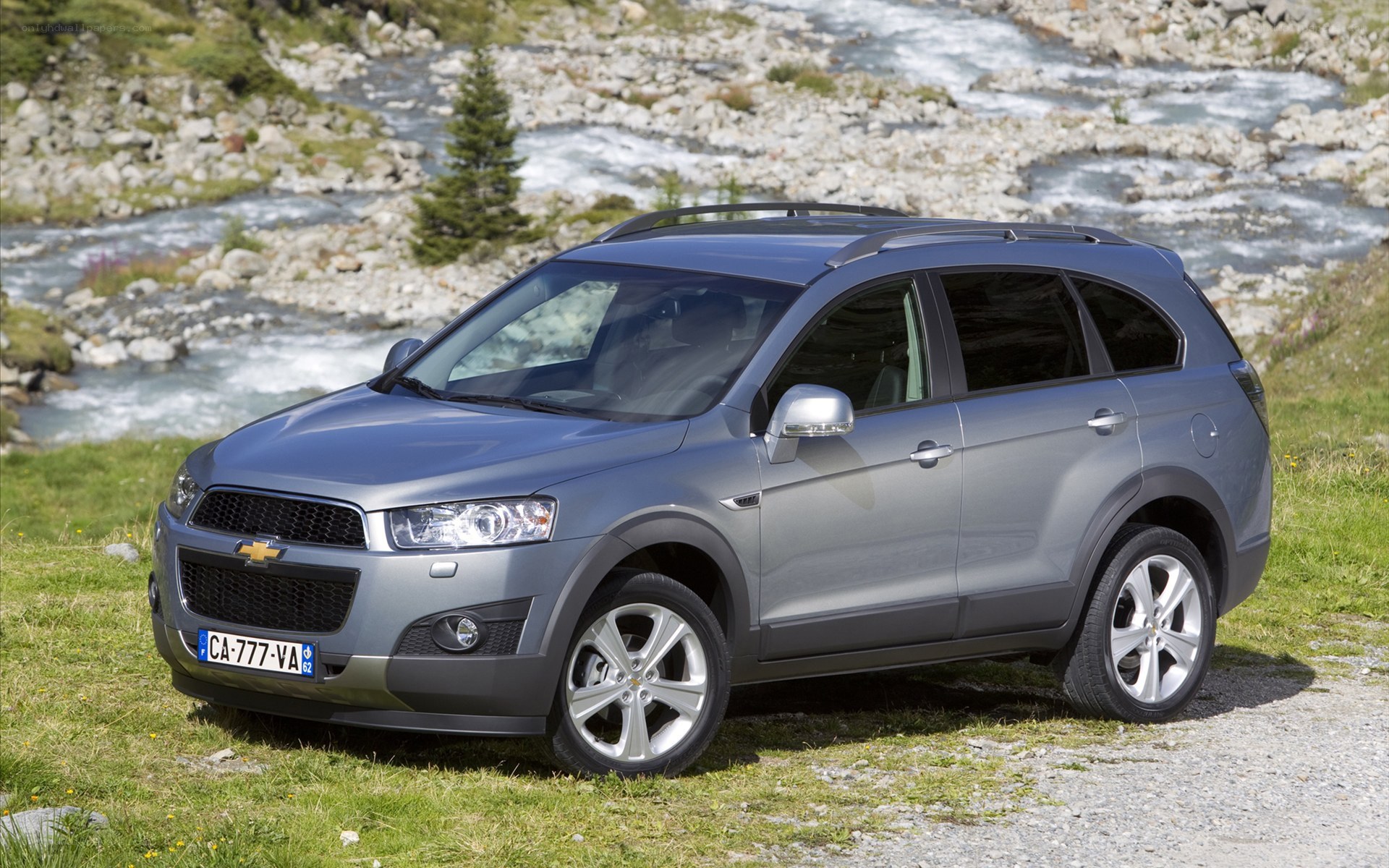 Silver Chevrolet Captiva parked by river
