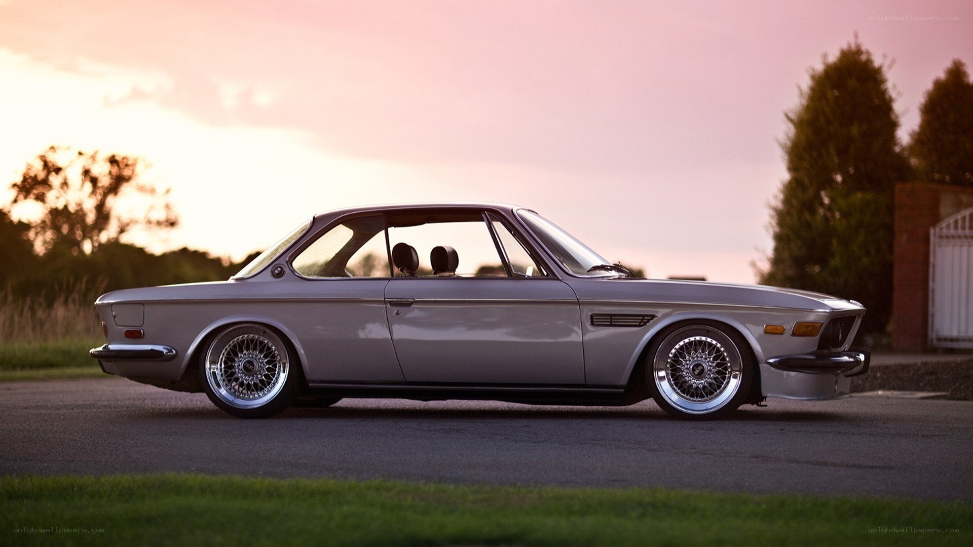 silver classic car at sunset
