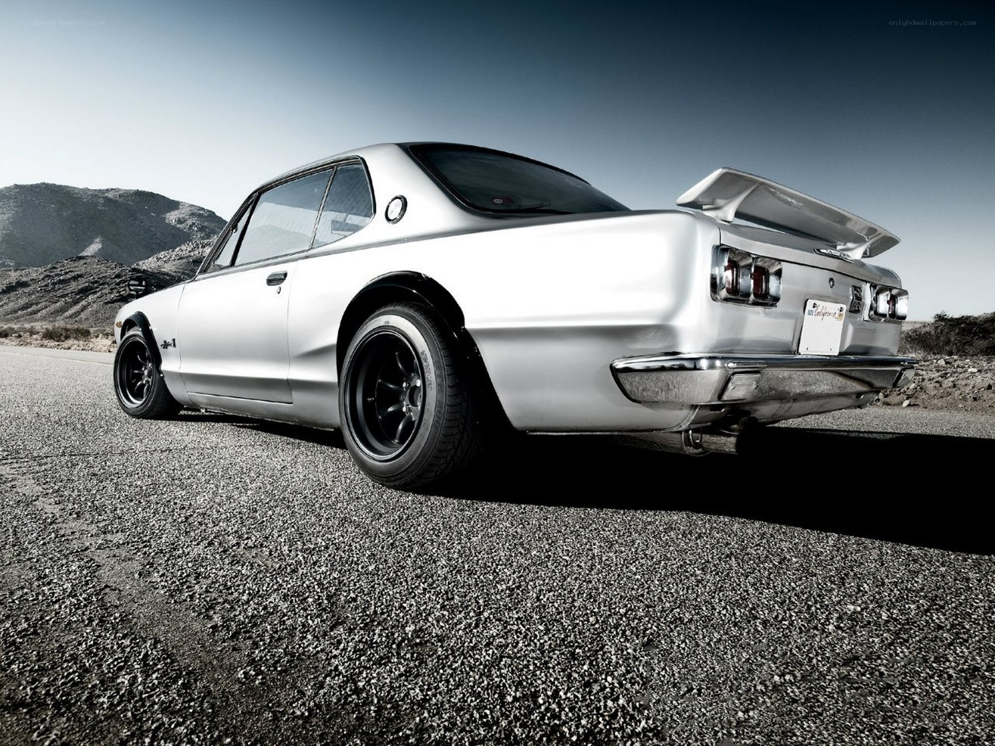 silver classic car on desert road