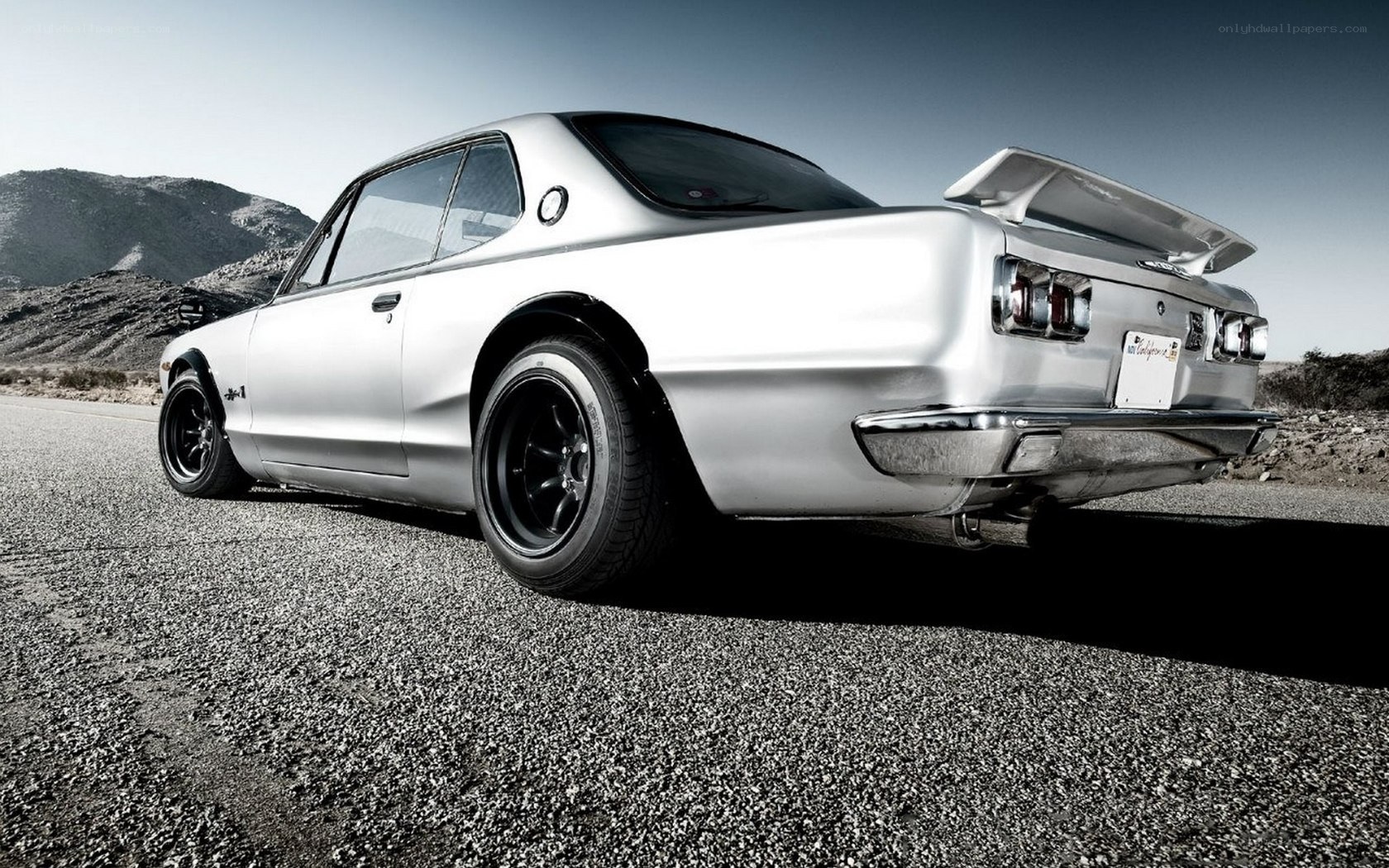 silver classic car on road