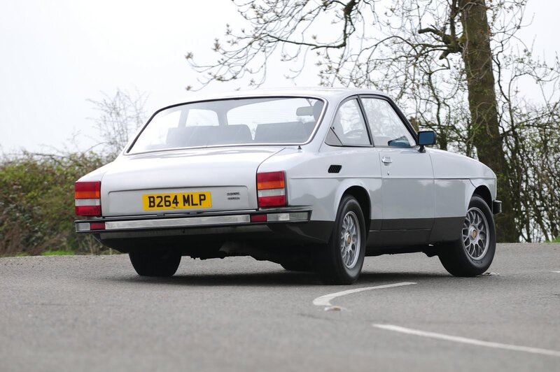 silver classic car on road