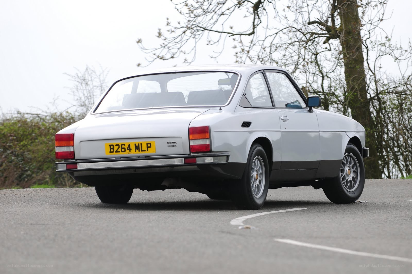 silver classic car on road