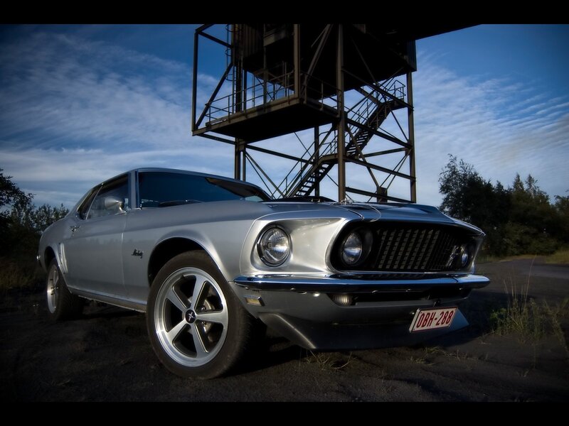 Silver classic car under tower