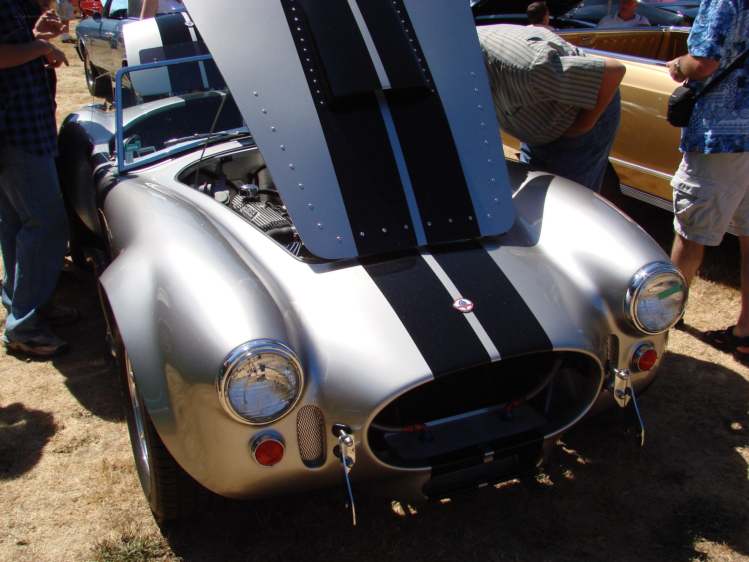 Silver classic car with open hood