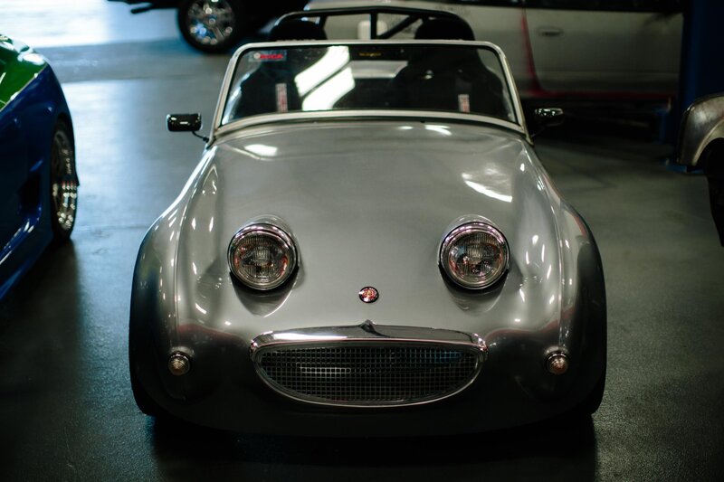 Silver classic sports car in garage