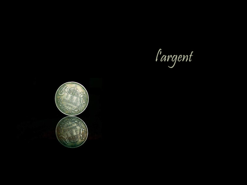 silver coin on black background