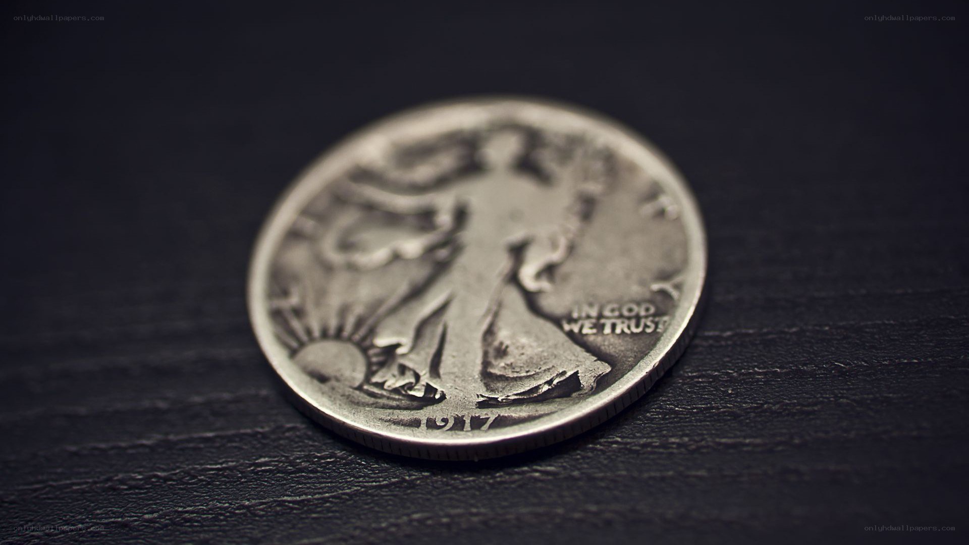silver coin on dark surface