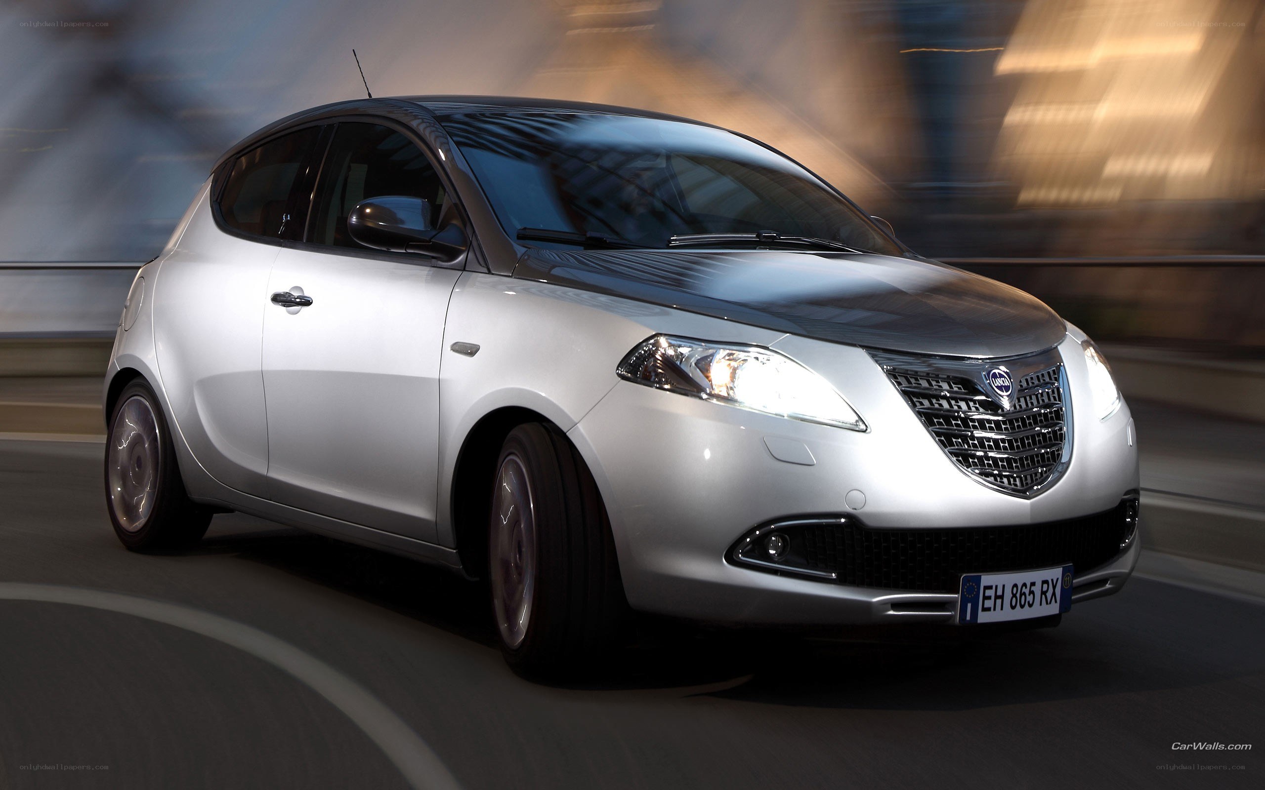 silver compact car in motion